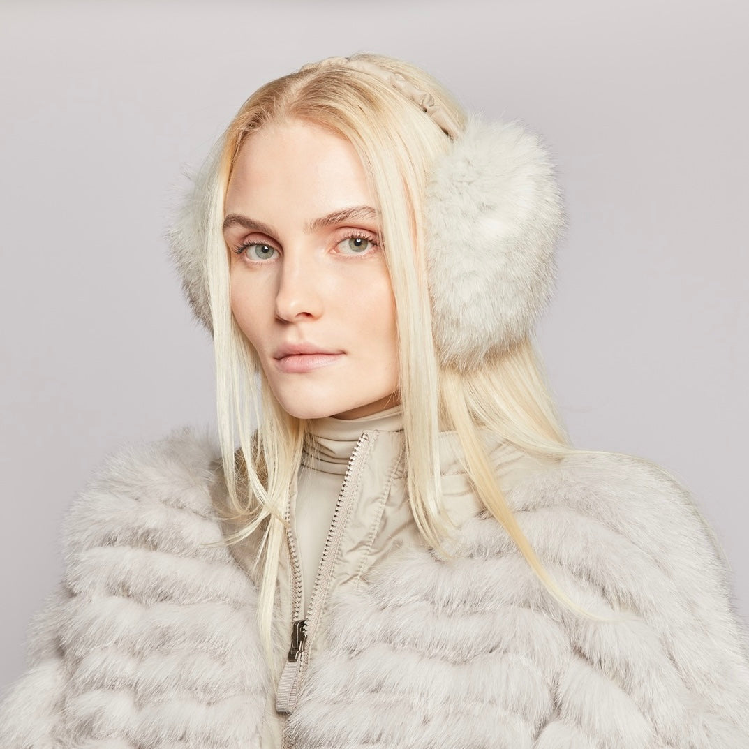 Woman wearing fur earmuffs and a light reversible fur coat