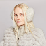 Woman wearing fur earmuffs and a light reversible fur coat