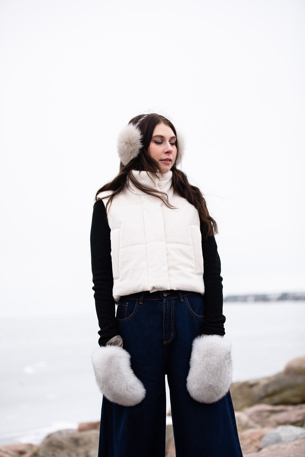 a lady wearing warm, luxurious fox fur mittens