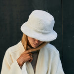 A-lady-wearing-a-warm-shearling-bucket-hat-made-from-curly-Italian-lambskin