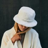 A-lady-wearing-a-warm-shearling-bucket-hat-made-from-curly-Italian-lambskin