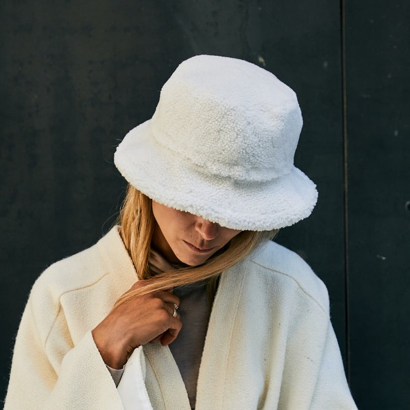 A-lady-wearing-a-warm-shearling-bucket-hat-made-from-curly-Italian-lambskin
