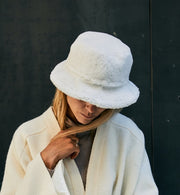 A-lady-wearing-a-warm-shearling-bucket-hat-made-from-curly-Italian-lambskin