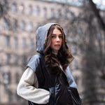 woman wearing a cropped light puffer gilet with hood 