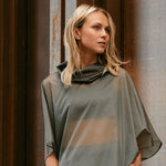 woman wearing a sheer windbreaker poncho 