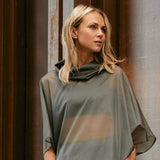 woman wearing a sheer windbreaker poncho 
