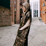 A lady wearing an ultralight warm puffer vest that is reversible and  easy to wear 