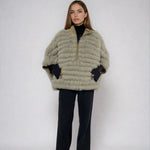 woman wearing a reveisible fox fur poncho 