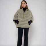 woman wearing a reveisible fox fur poncho 