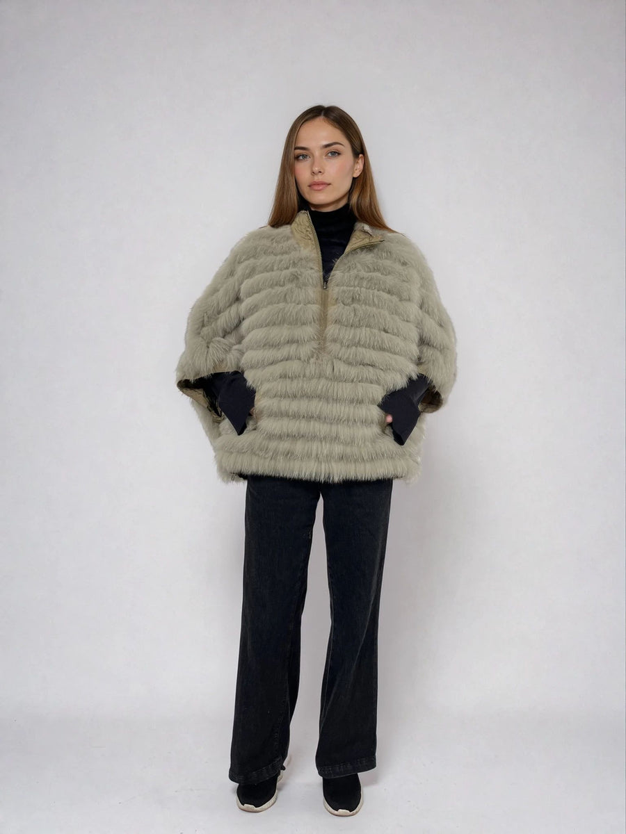 woman wearing a reveisible fox fur poncho 