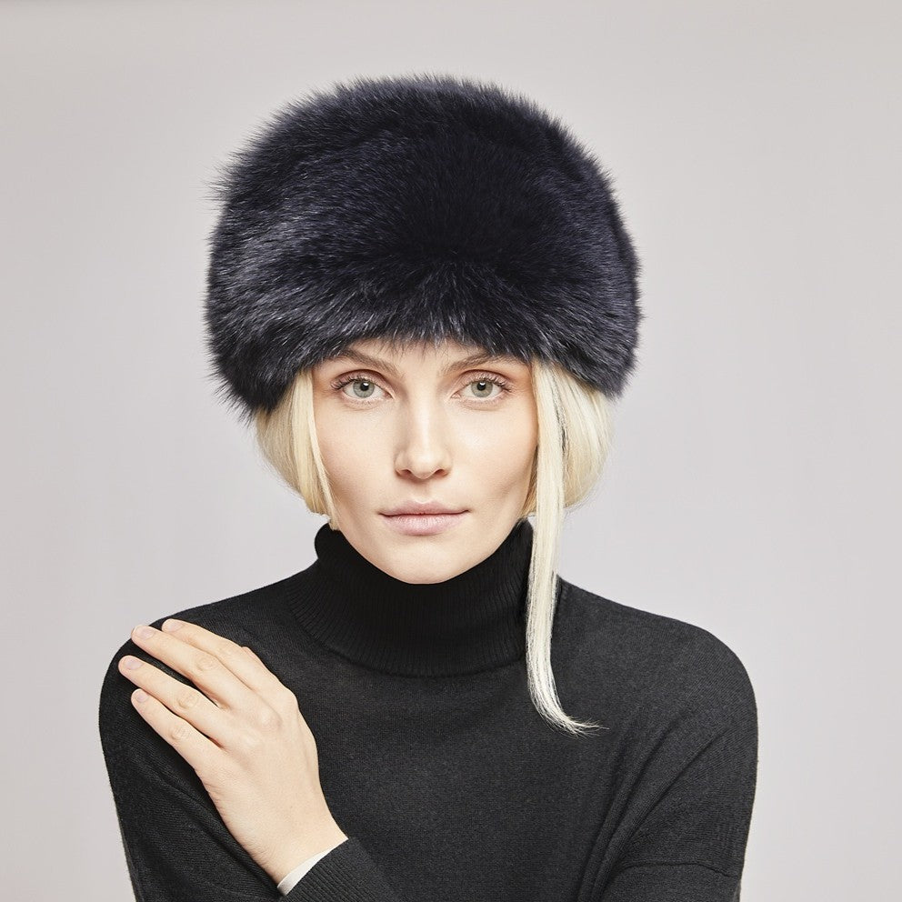 A lady wearing a black fox fur hat made in FInland 