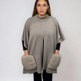 KNITTED PONCHO WITH FUR POCKETS