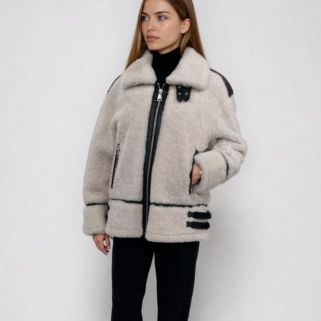 A woman wearing a white shrearling jacket 
