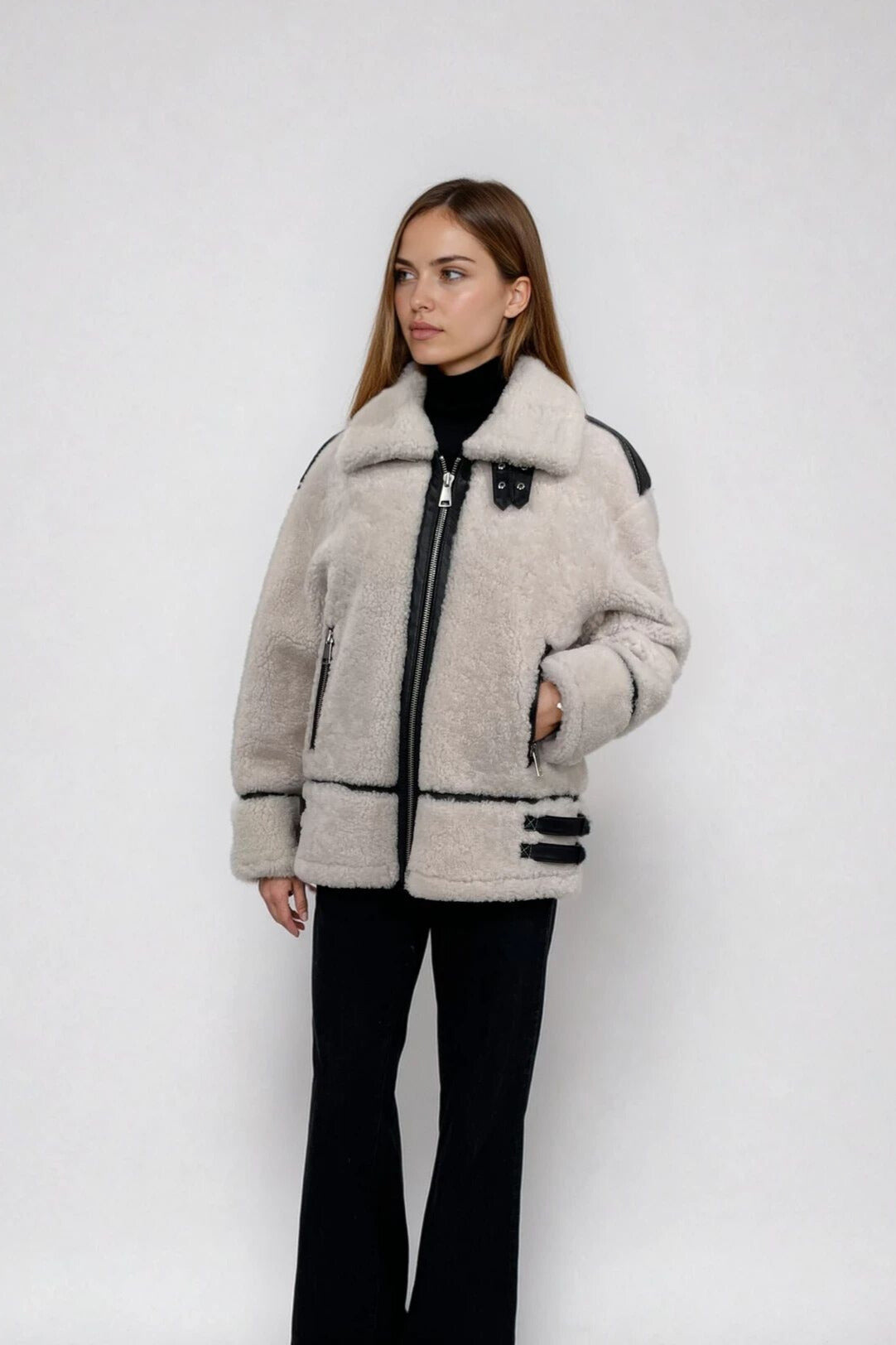 A woman wearing a white shrearling jacket 