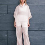 woman wearing a light windbreaker set with poncho and pants suitable for Summer 