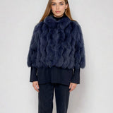 woman wearing a cropped fox fur jacket in blue color 