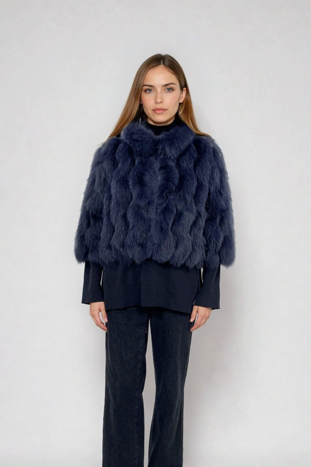 woman wearing a cropped fox fur jacket in blue color 