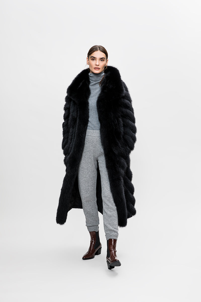 A long reversible black fox fur coat with a large collar
