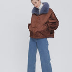 A reversible bomber-style jacket, with luxurious fox fur lining.  The left sleeve on both sides has a pocket with zipper, perfect for the ski lift card. The jacket has a loose fit and hood has a fox fur trim in a contrasting color.