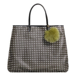 Fur pom pom decorating a black bag