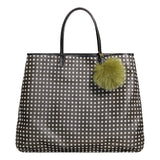 Fur pom pom decorating a black bag