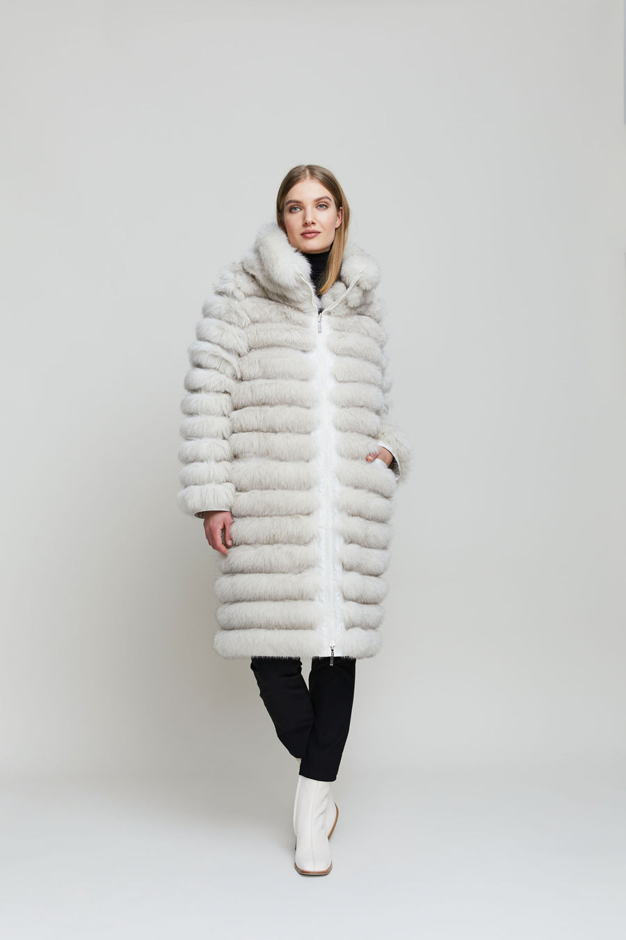 A reversible fox fur coat, that on one side resembles a padded coat, and on the other side is a fur coat with a rounded back, giving the coat a contemporary look