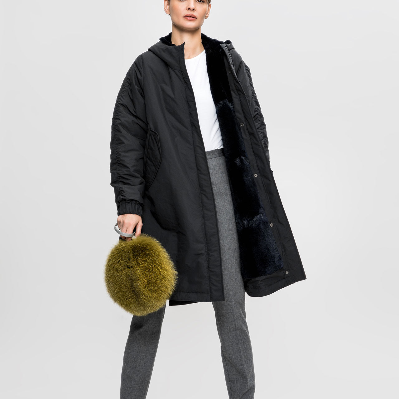 Lady modelling Fox fur pouch with a Short leather wrist strap and long webbing strap