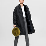 Lady modelling Fox fur pouch with a Short leather wrist strap and long webbing strap