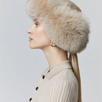 Fox fur trapper hat  has ear flaps that tie back in the neck or under the chin 