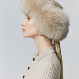 Fox fur trapper hat  has ear flaps that tie back in the neck or under the chin 