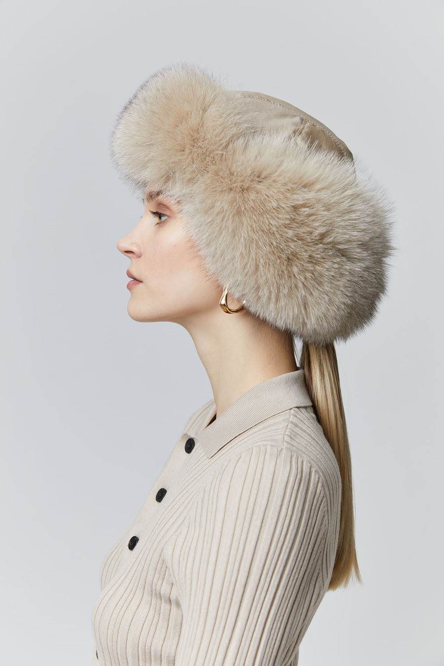 Fox fur trapper hat  has ear flaps that tie back in the neck or under the chin 