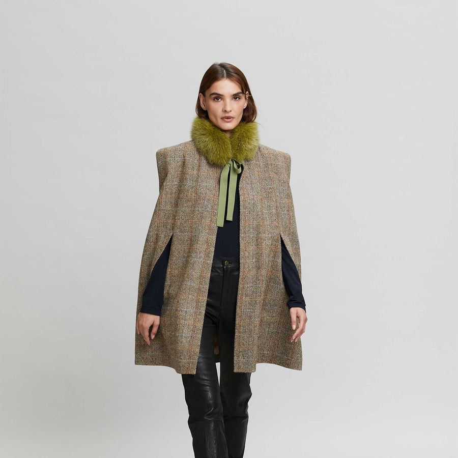 Lady modelling a Tweed cape with small fox fur collar. Part of the capsule collection Aki Choklat and Gemmi