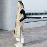 Lady modeling a limited edition vest is made from windproof and water repellent fabrics, with a soft down-like nonwoven lining. The vest has a collar and push button closing. 