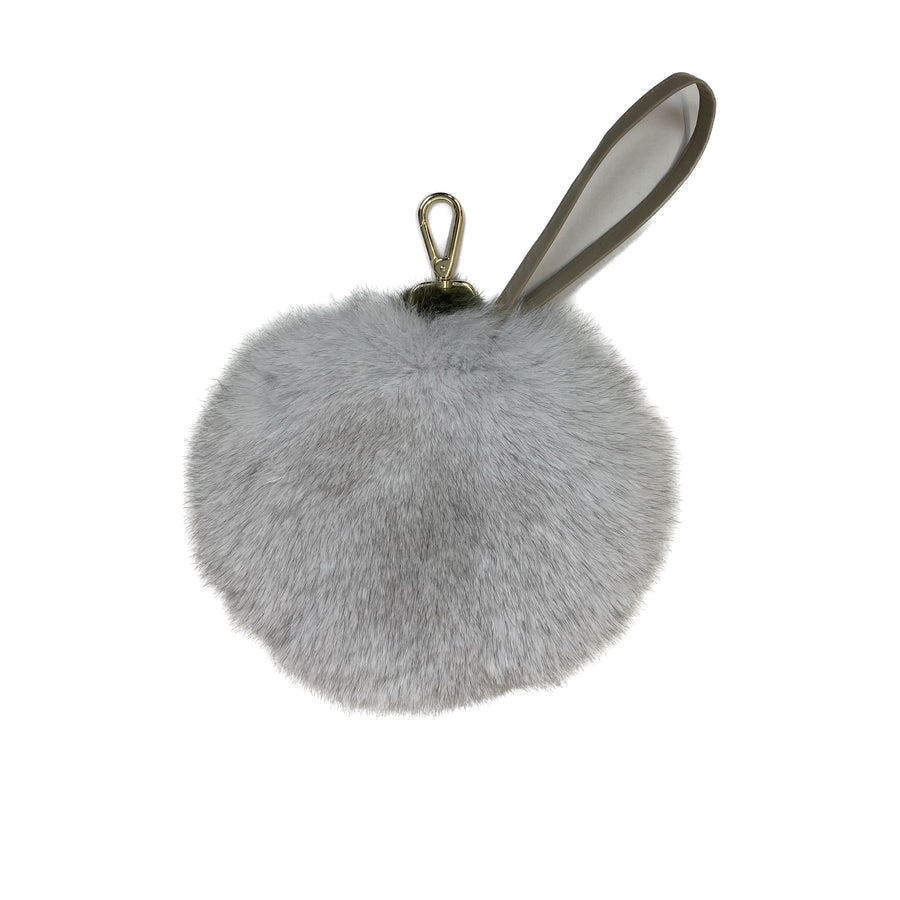 Round fox fur cross-body and wrist bag. The bag's opening has a magnet